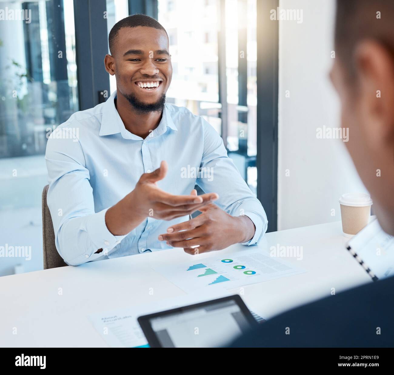 African man in business meeting with CEO planning corporate success strategy with graph and chart paperwork. Black businessman with idea presentation for boss or management leader at company office Stock Photo