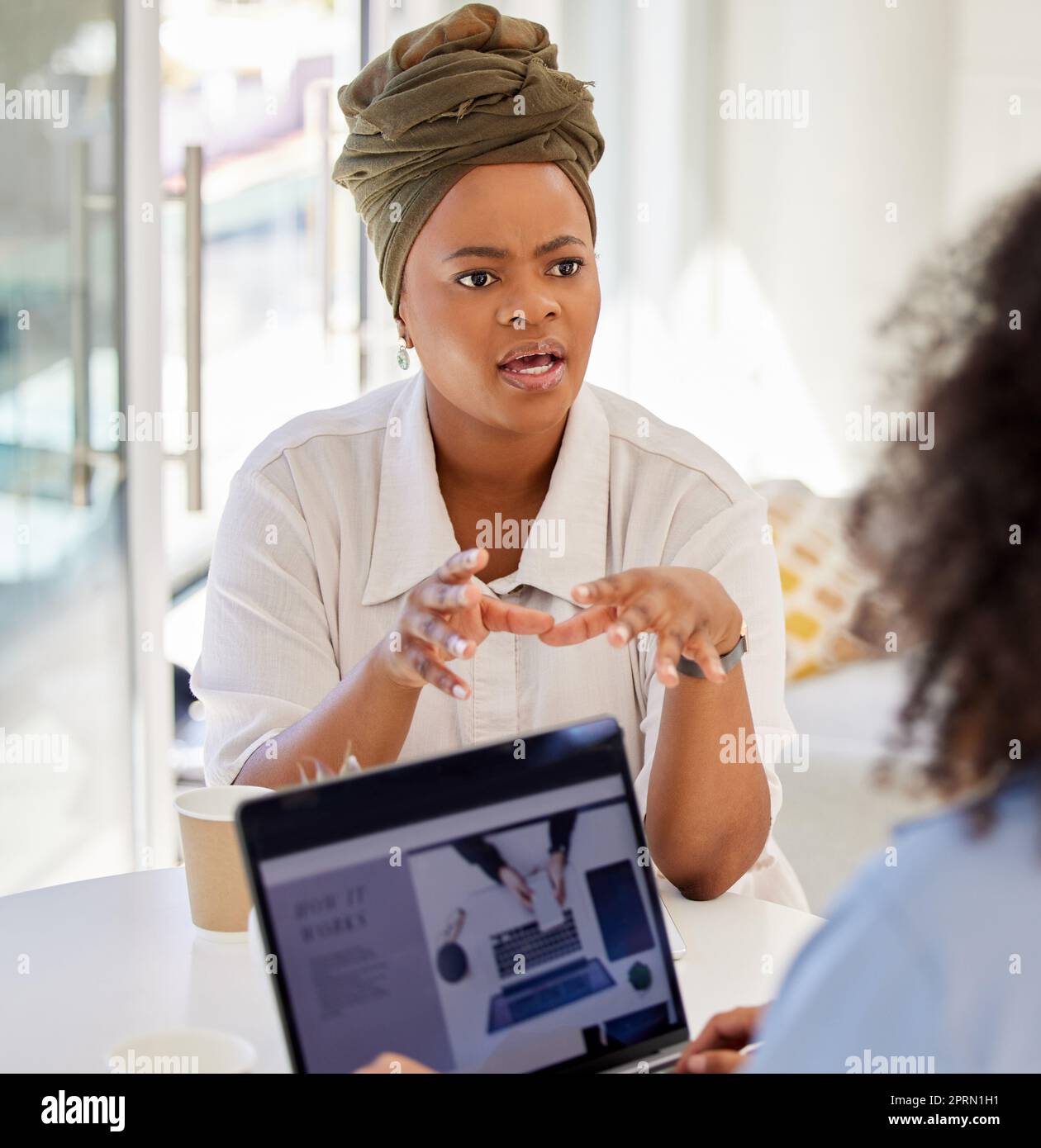 Coaching, mentor and business woman talking to employee in marketing, interview and consulting office building. Manager, coach and black woman working with colleague in vision, innovation and leader Stock Photo