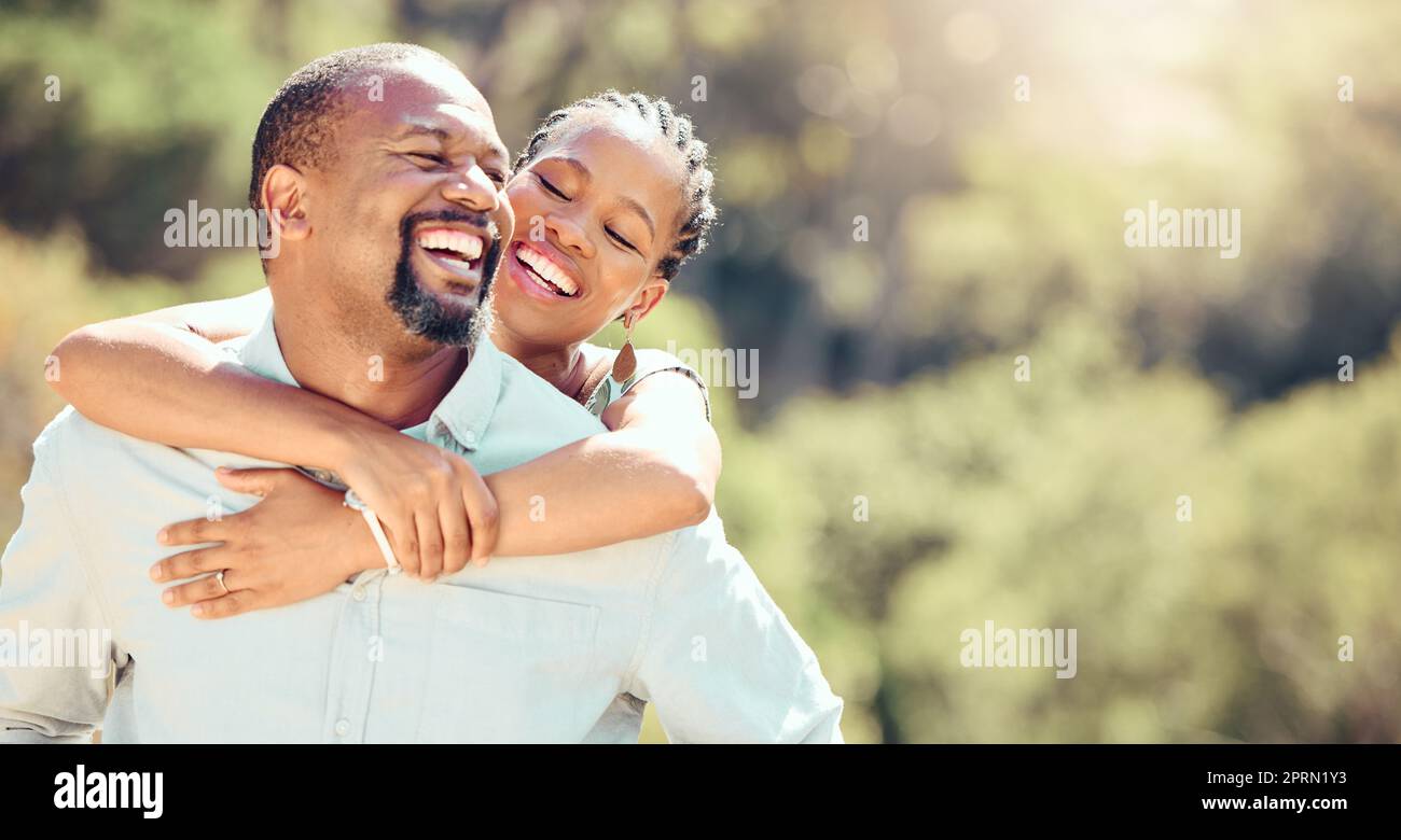 Happy, love and outdoor couple on a date in park or green nature environment for a healthy and wellness lifestyle. Freedom and carefree man, woman or boyfriend and girlfriend enjoying the summer sun Stock Photo