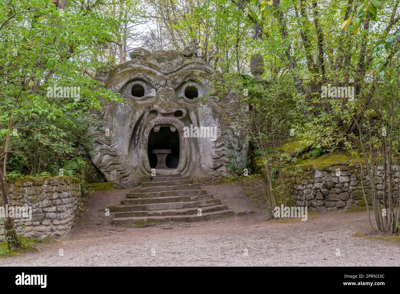 The ancient statue representing the ogre, in the park of monsters in Bomarzo, Italy (Translation: Every thought flies) Stock Photo