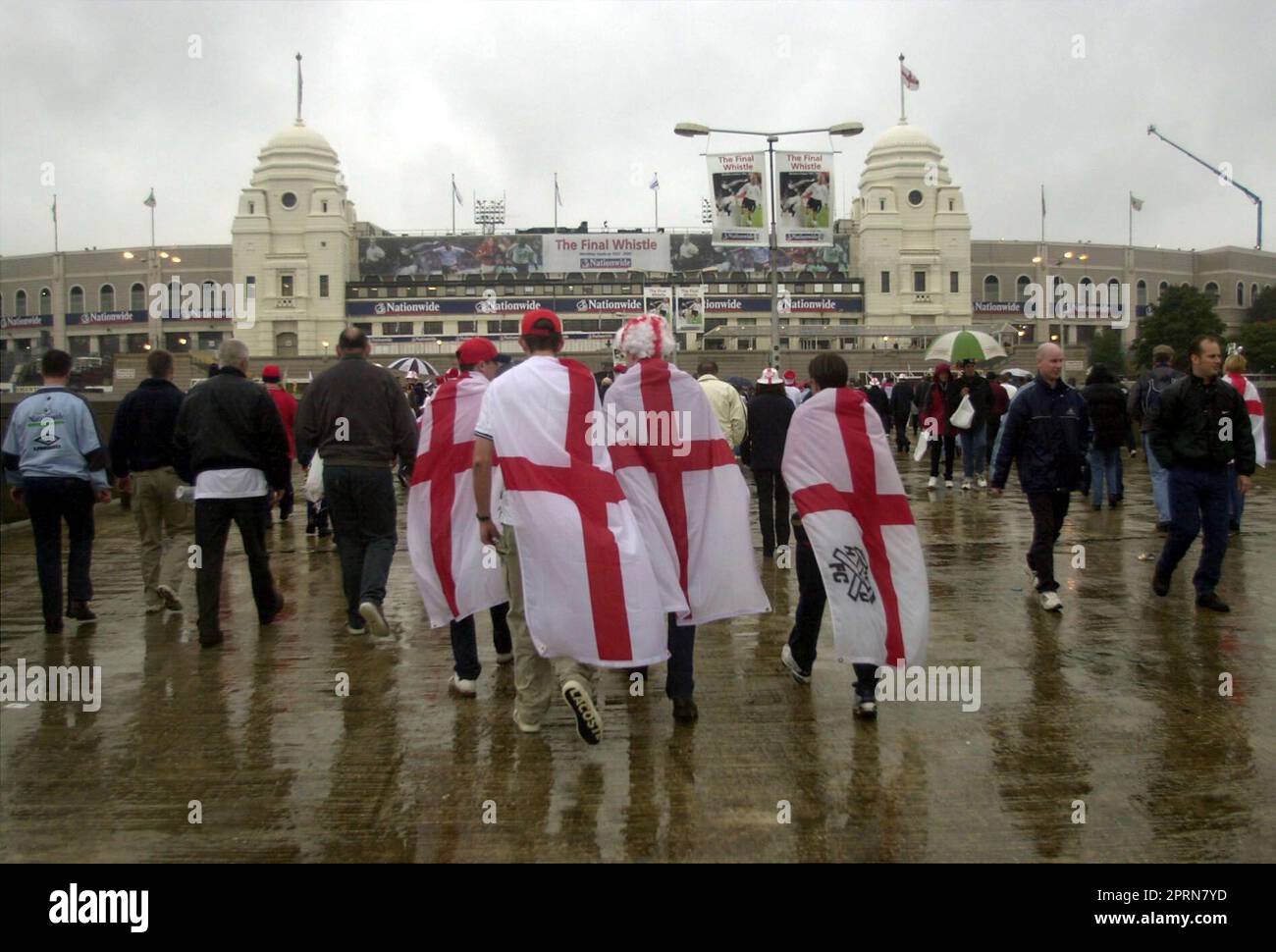 File photo dated 07-10-2000 of England supporters walking down a rain-soaked Wembley Way to Wembley Stadium, London, where England play Germany, 2000, in a World Cup Qualifying match, the last football match before the stadium is rebuilt. England fans headed into the old Wembley for its final match, a 1-0 defeat to Germany in a qualifier for the 2002 World Cup on October 7, 2000. Issue date: Thursday April 27, 2023. Stock Photo