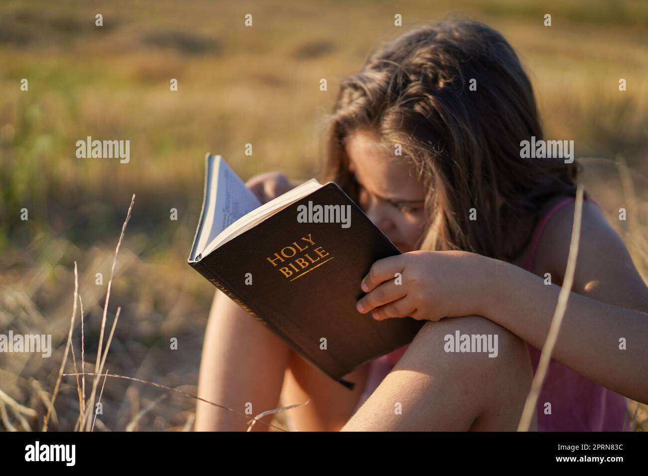 Christian girl holds bible in her hands. Reading the Holy Bible in a