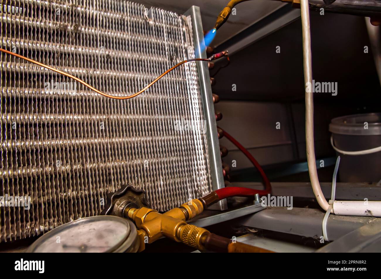 Soldering copper pipes of the refrigerator with oxygen welding. Oxygen