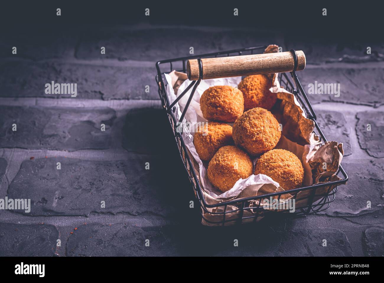 Homemade Arancini deep fried rice balls stuffed with Mozzarella