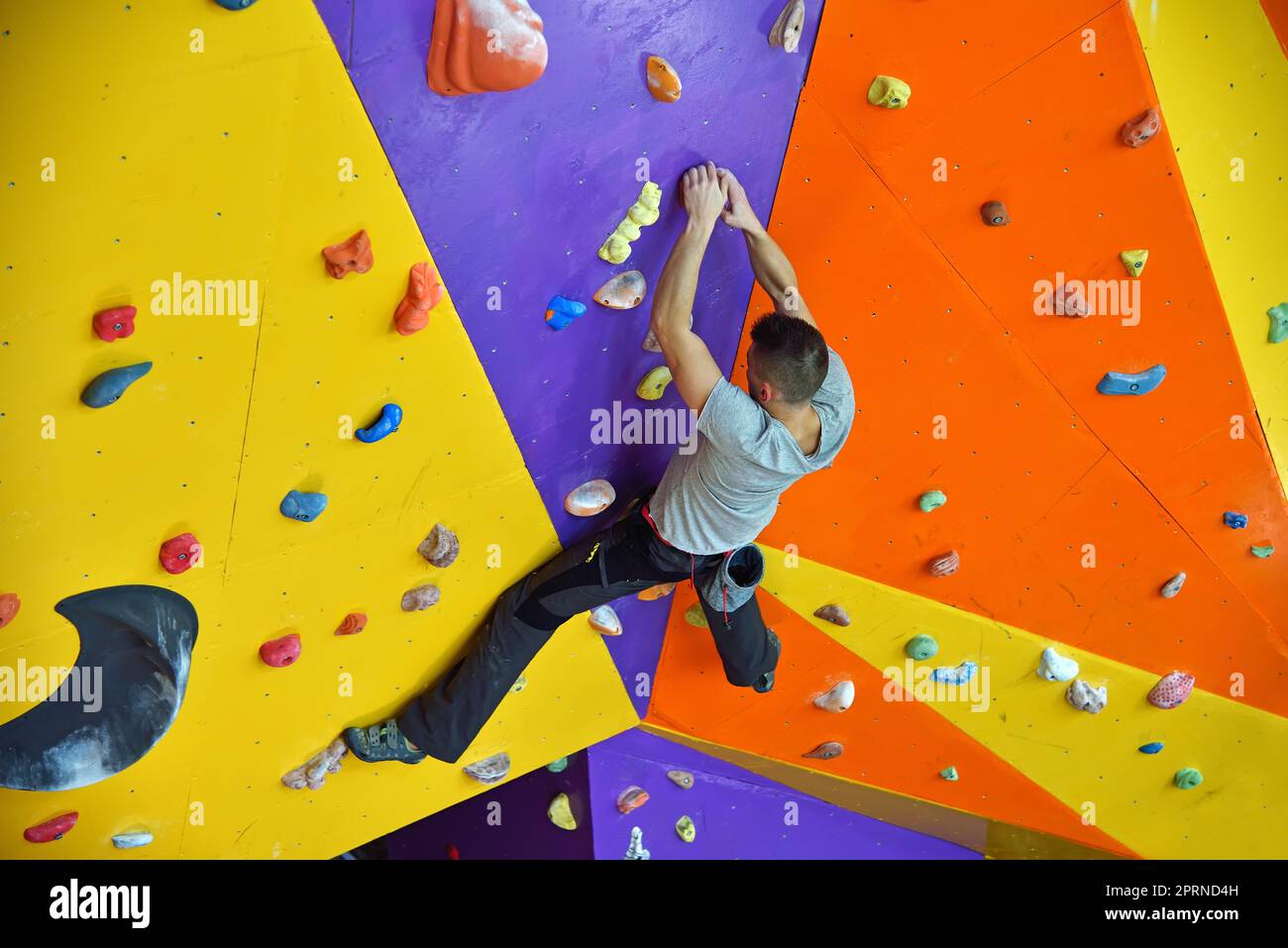 Free Climber Man Climbing On Practice Wall Indoors Stock Photo