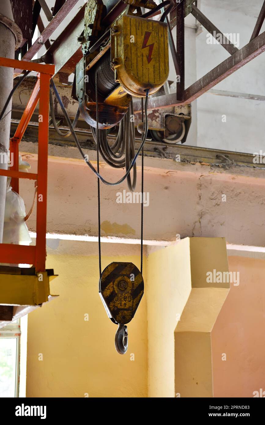 Industrial crane hook in a building interior Stock Photo