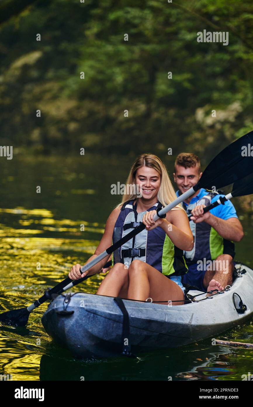 Kayak Riding A young couple enjoying an idyllic kayak ride in the middle of a ...