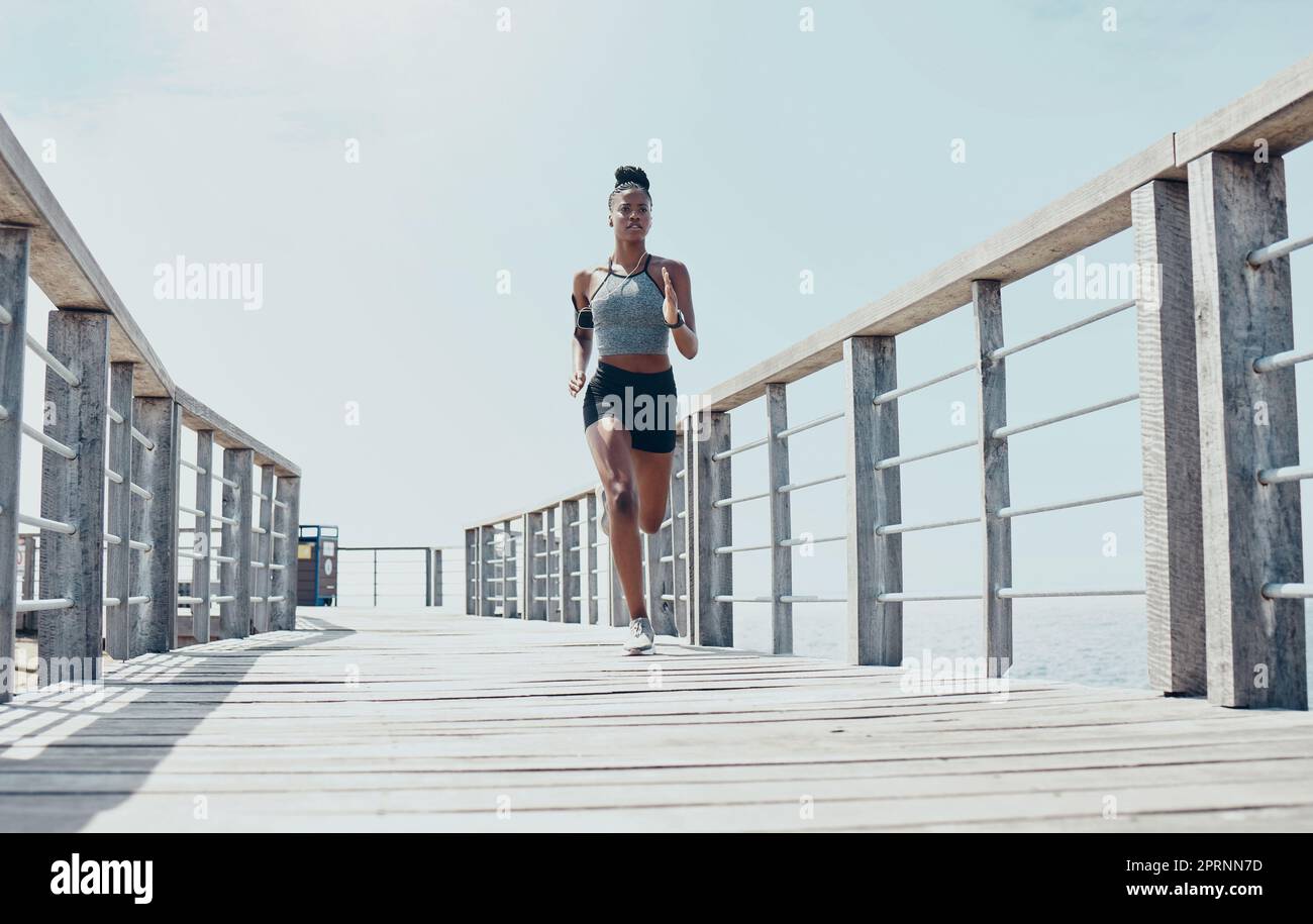 Fitness, exercise and running with black woman on bridge with morning