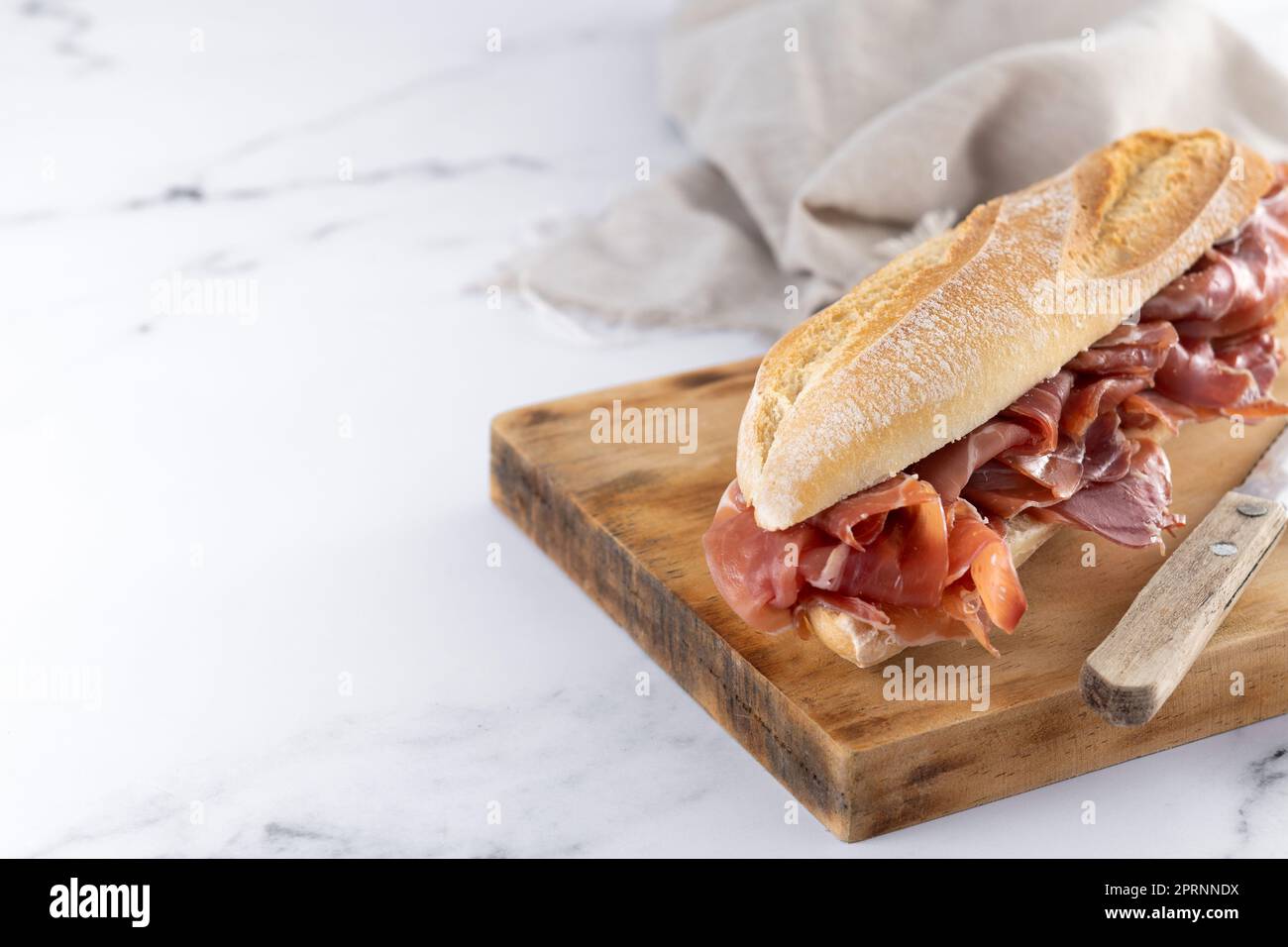 Spanish serrano ham sandwich on marble background Stock Photo Alamy
