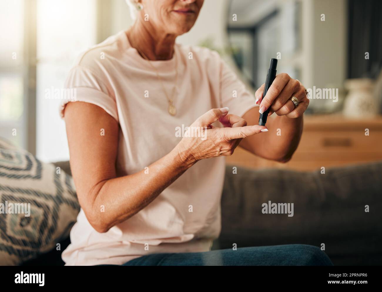 Diabetes, health and elderly woman doing a blood sugar test on her