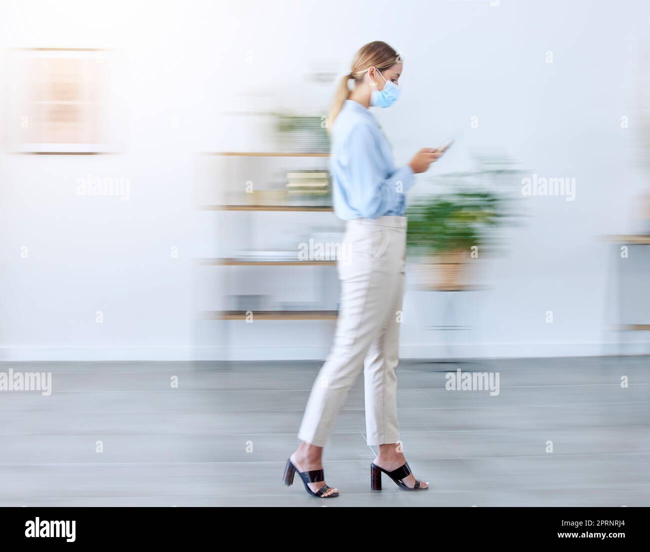 Covid mask in office, woman walking with phone doing business in fast