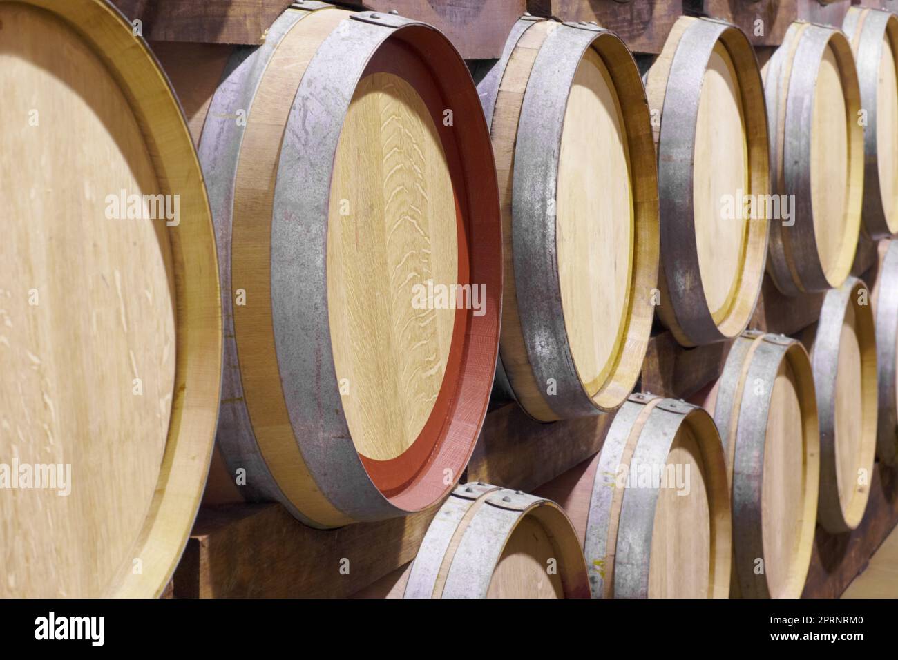 Barrels full of wine. barrels of wine stacked up against each other