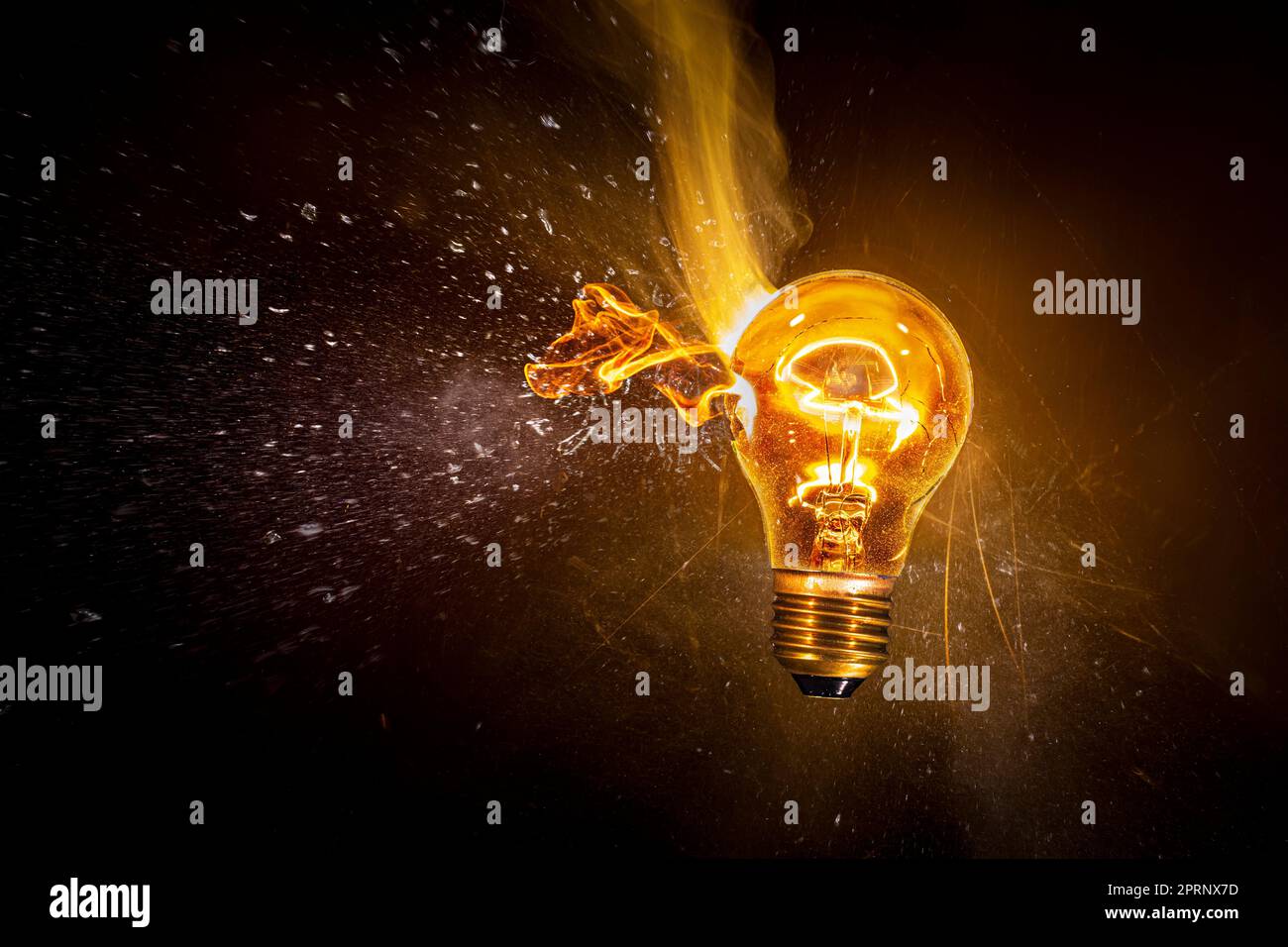 Broken electric bulb explodes and catches fire Stock Photo