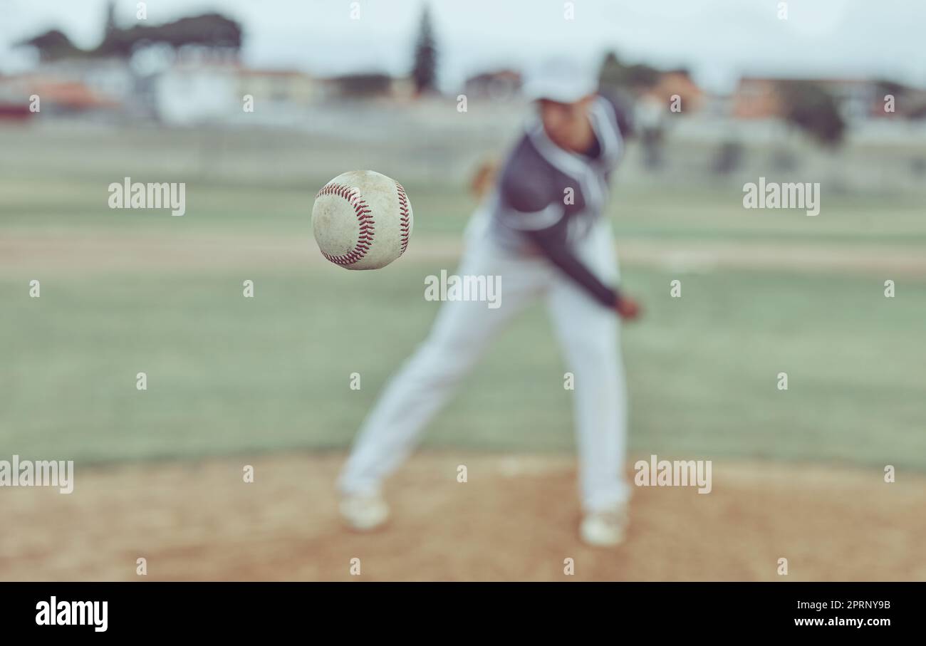 Baseball, sports and athlete pitching with a ball for a match or training on outdoor field. Fitness, softball and pitcher practicing to throw with equ Stock Photo