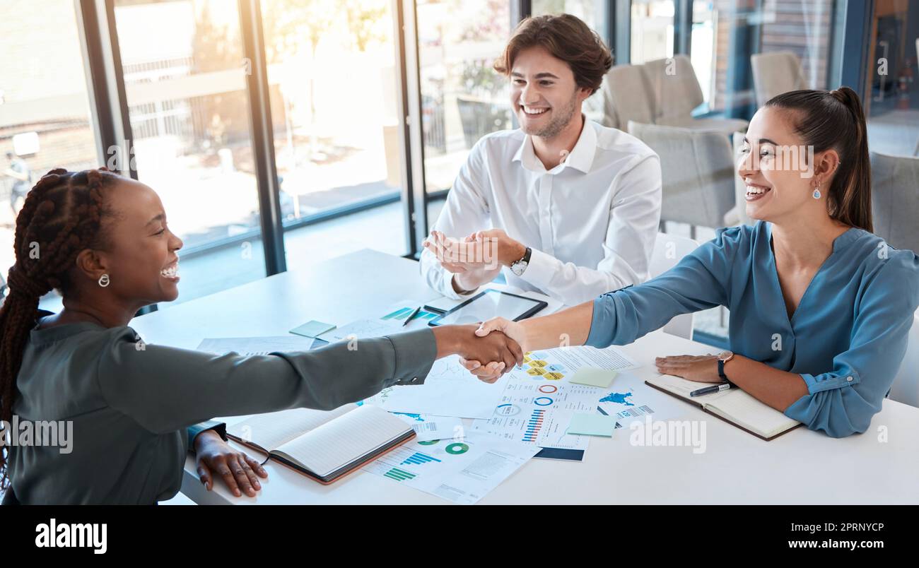 Business people, handshake and working together, deal or agreement in meeting. B2b, thank you and shaking hands in partnership, teamwork or collaboration together with client in corporate office. Stock Photo