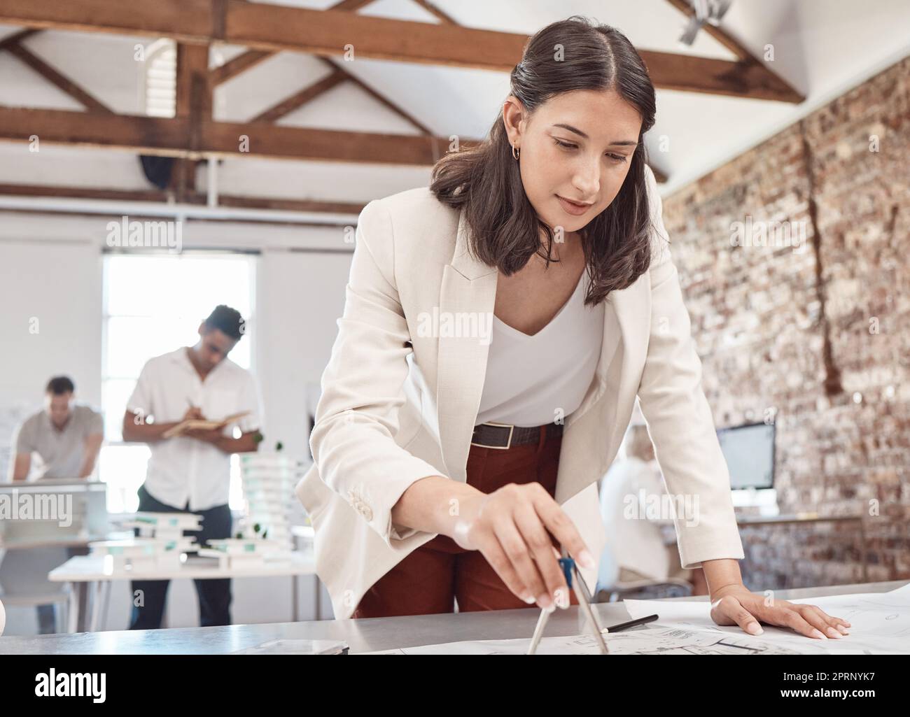 Architect, blueprint and design with a woman engineer working on a plan in her office at work. Construction, designer and architecture with a female creative working on building plans for development Stock Photo