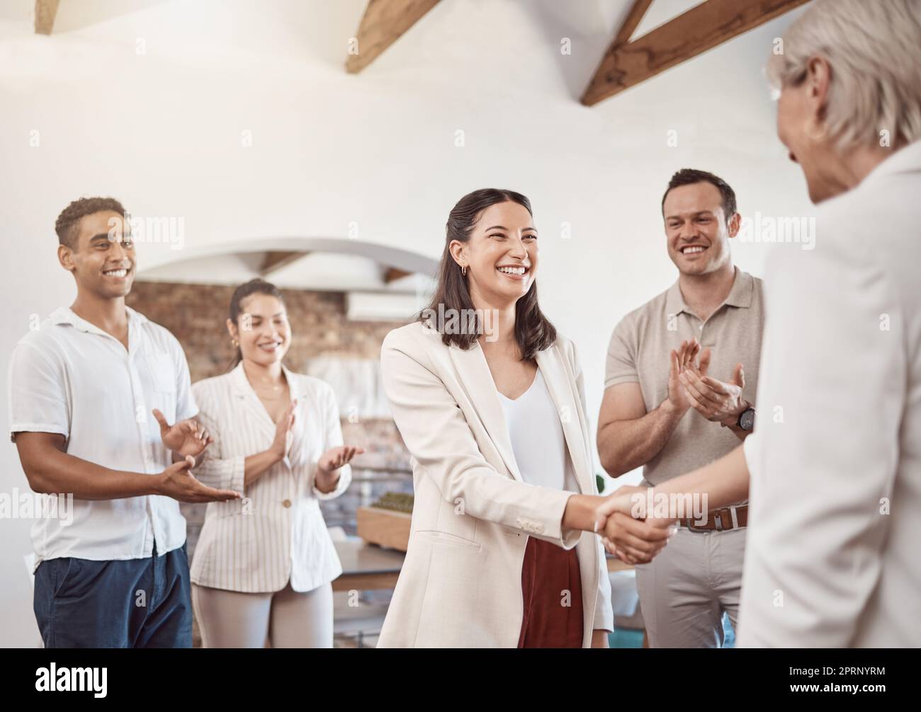 Business handshake with clapping workers in the work office. Professional company b2b shaking hands for a deal to come and work together. Diverse group of happy staff thank you and welcome employee Stock Photo