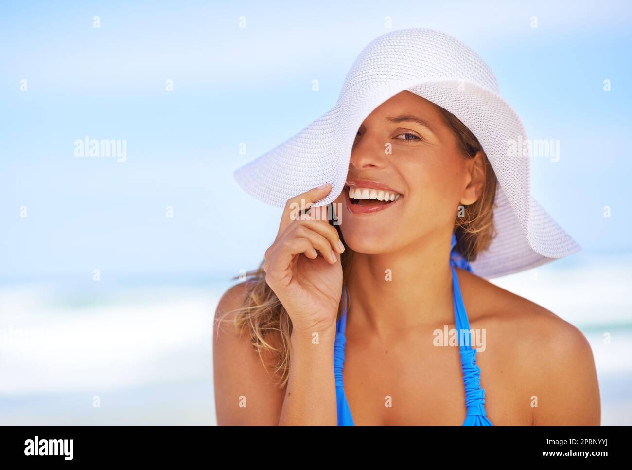 Sunshine and smiles. a beautiful young woman at the beach. Stock Photo