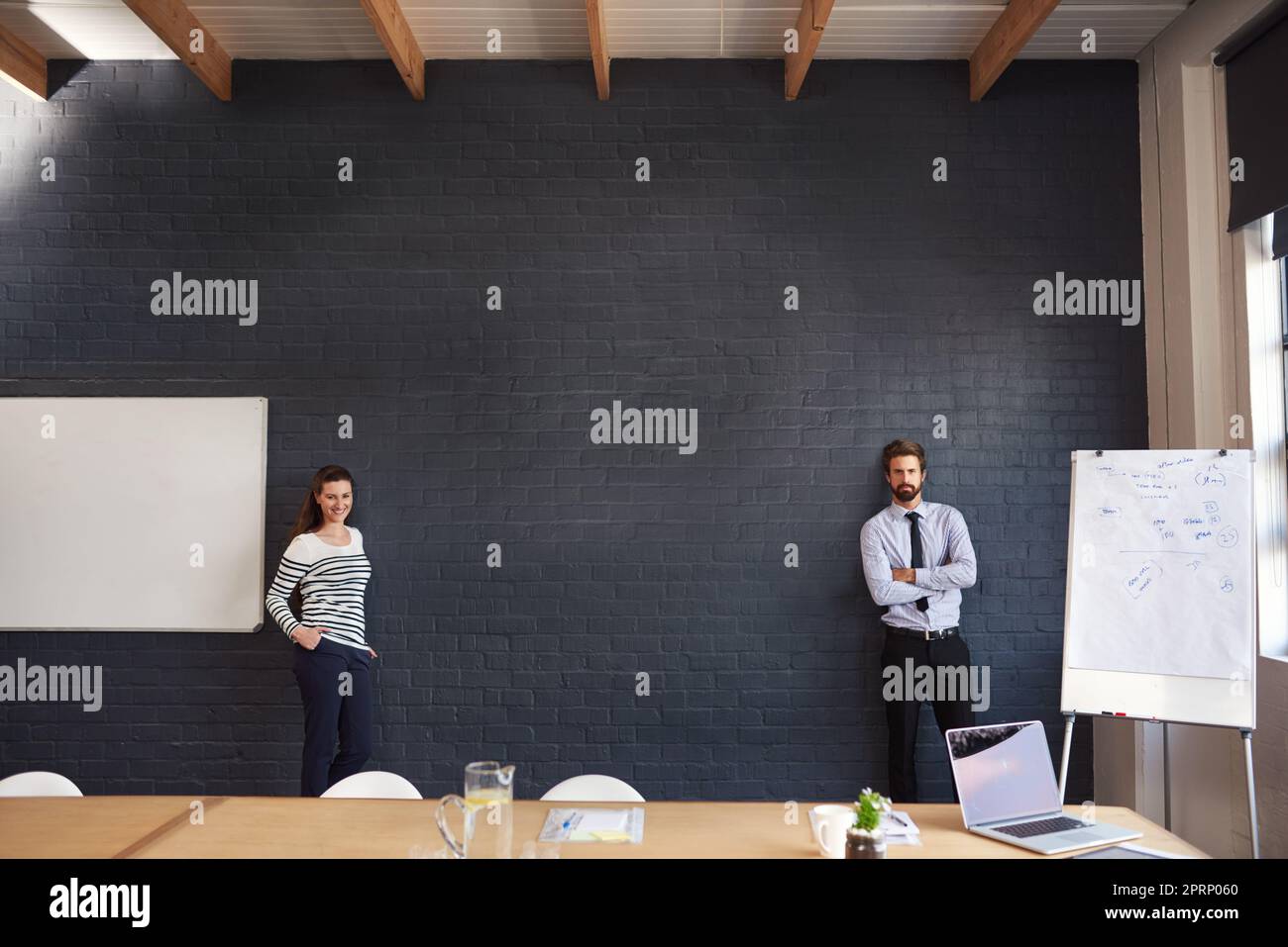 The perfect pair to present your product. Portrait of two young businesspeople standing in the boardroom. Stock Photo