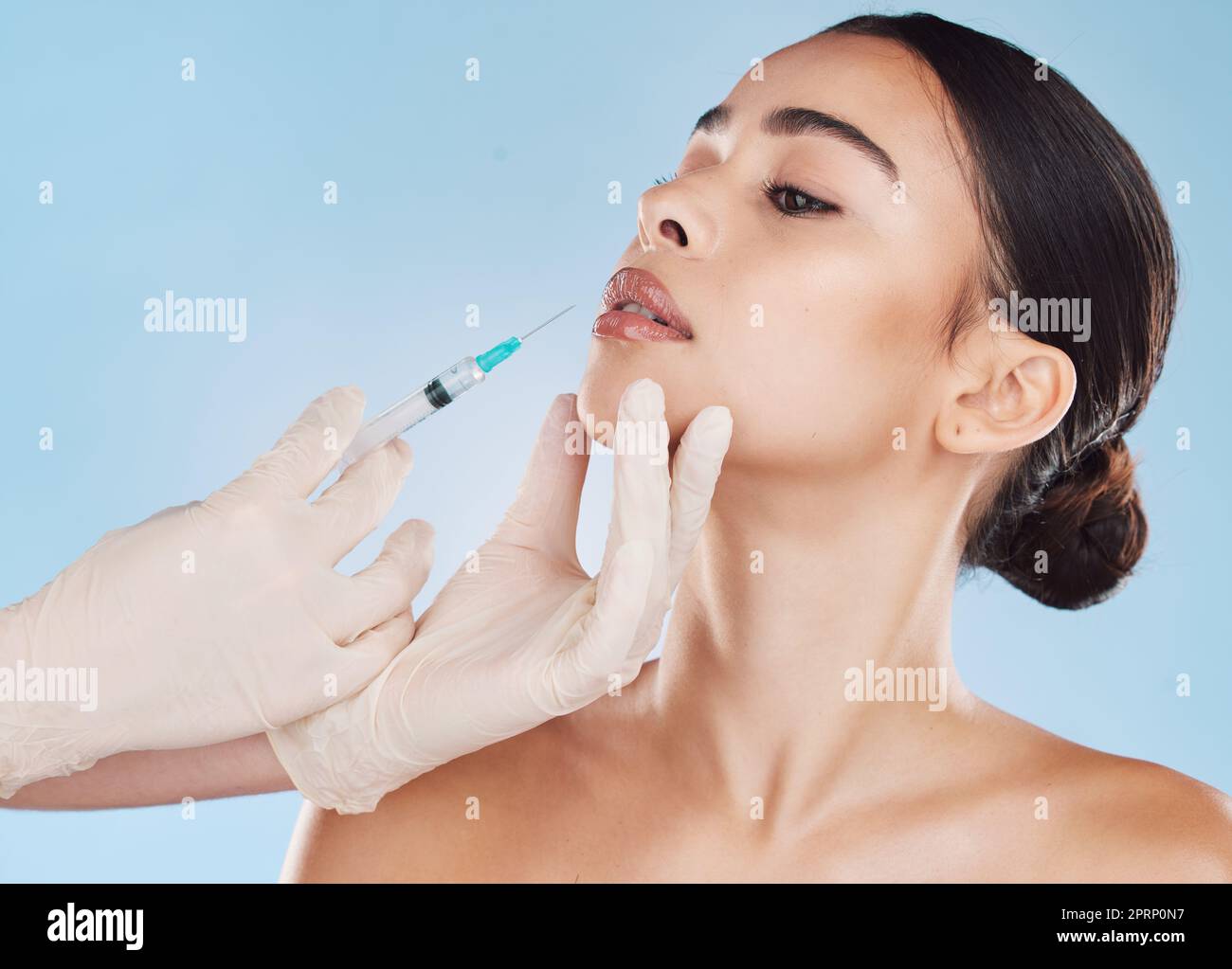 Plastic surgery, botox and lip filler on woman for facial beauty aesthetic and medical cosmetic. Hands and female face augmentation surgeon or doctor working on patient lips with injection needle. Stock Photo