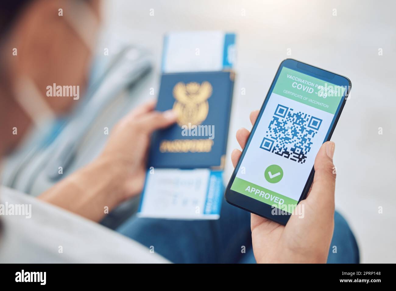 Covid vaccine passport on a phone for travel, safety or security in global pandemic. Airport, smartphone app with digital health certificate qr code and South Africa book for international traveling Stock Photo