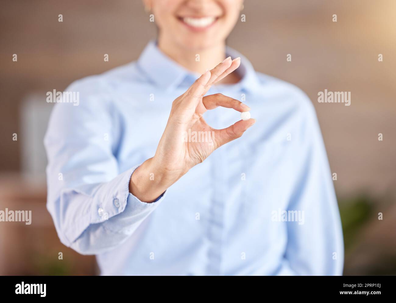 Pill, medicine and product in woman hand for healthcare and medical wellness. Success, insurance and trust of a professional sales pharmacist or pharmaceutical worker or doctor in retail pharmacy Stock Photo