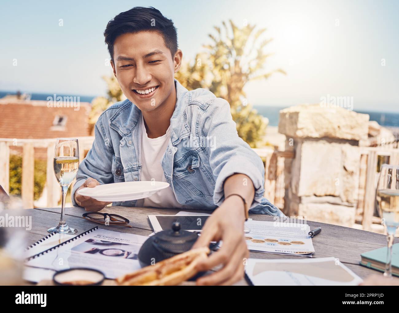 Man eating food in lunch meeting at restaurant, worker planning career growth at coffee shop and hungry while working with meal at cafe. Happy person with smile at employee business workshop Stock Photo