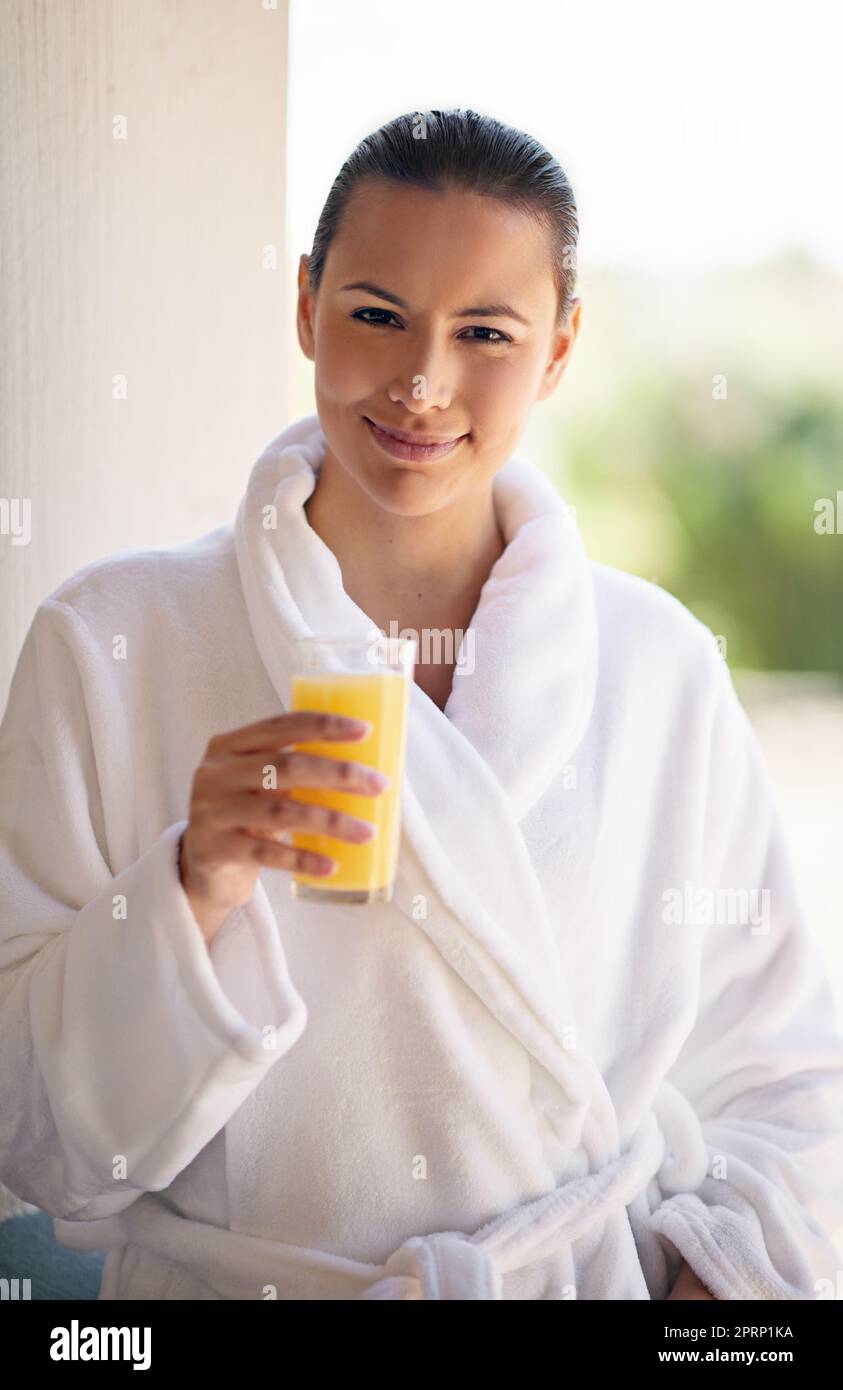 Every girl deserves a spa day. a young woman drinking a glass of orange