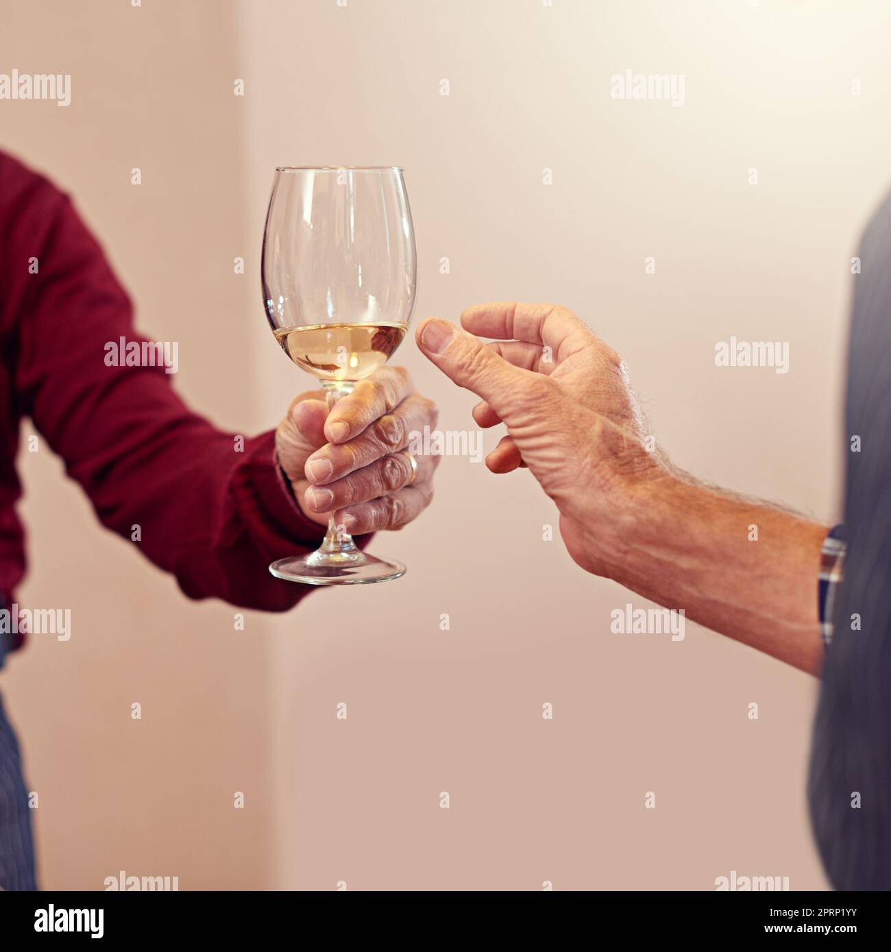 Join the celebration. a person handing over a glass of champagne. Stock Photo