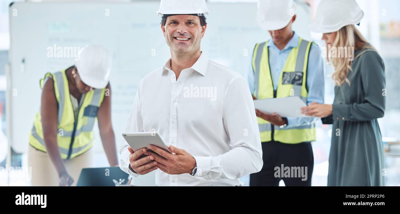 Architect, engineer and designer working on tablet, planning construction building job on mobile app and home renovation with workers at work. Portrait of happy manager and boss in architecture Stock Photo