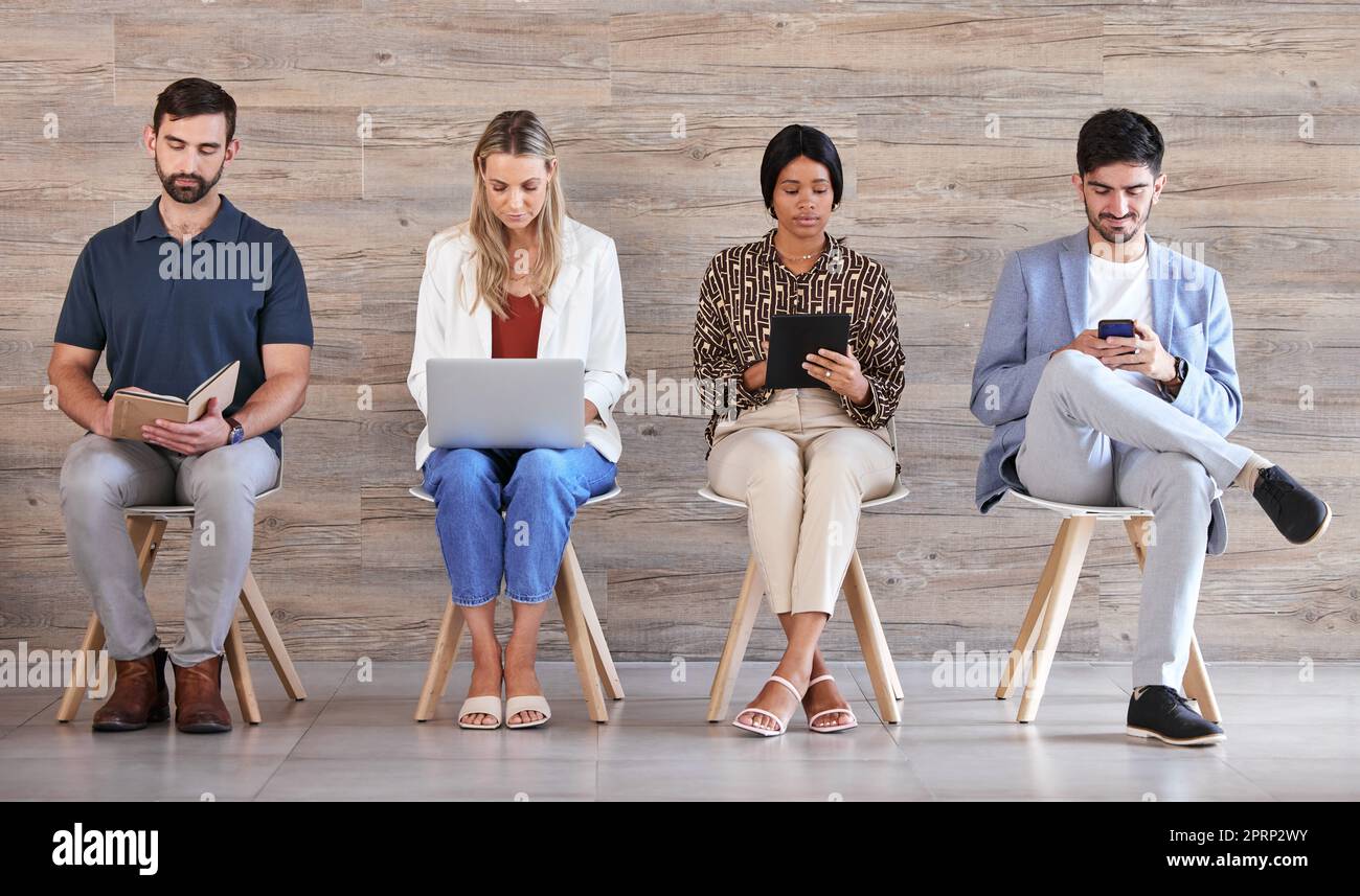 Business people waiting at interview or recruitment for work in a line, networking on tablet, cellphone and planning in a office together. Corporate employee, worker and professional at job center Stock Photo