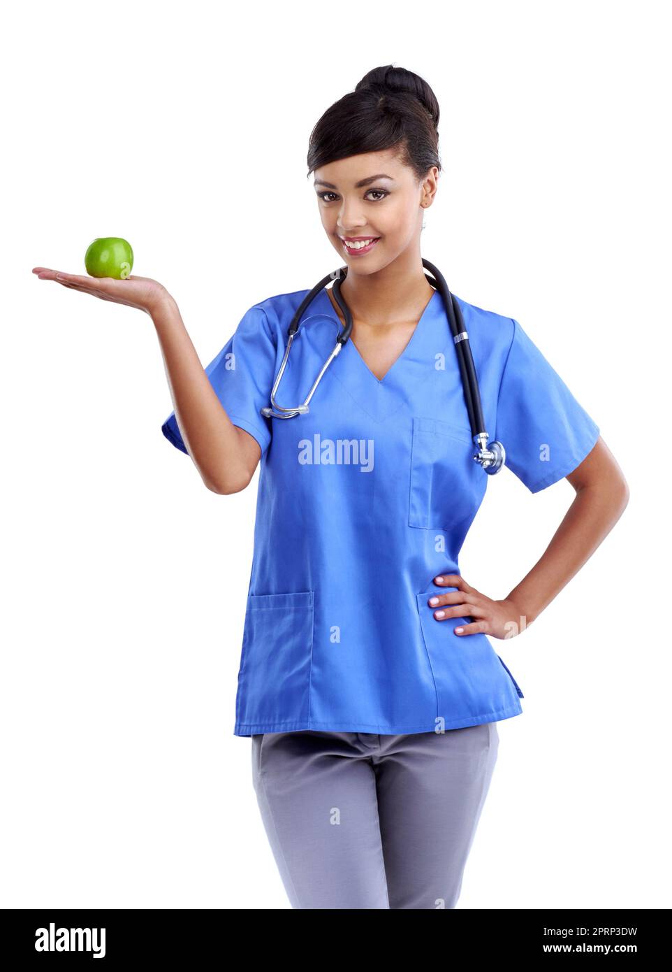 So many vitamins packed in a little snack. Studio shot of a young medical professional holding an apple isolated on white. Stock Photo