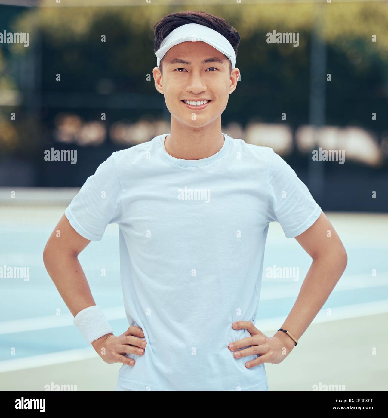 Face portrait of tennis player training for competition on court, learning game of sports for fitness and sport exercise for health in summer. Asian and happy man and athlete ready for cardio workout Stock Photo