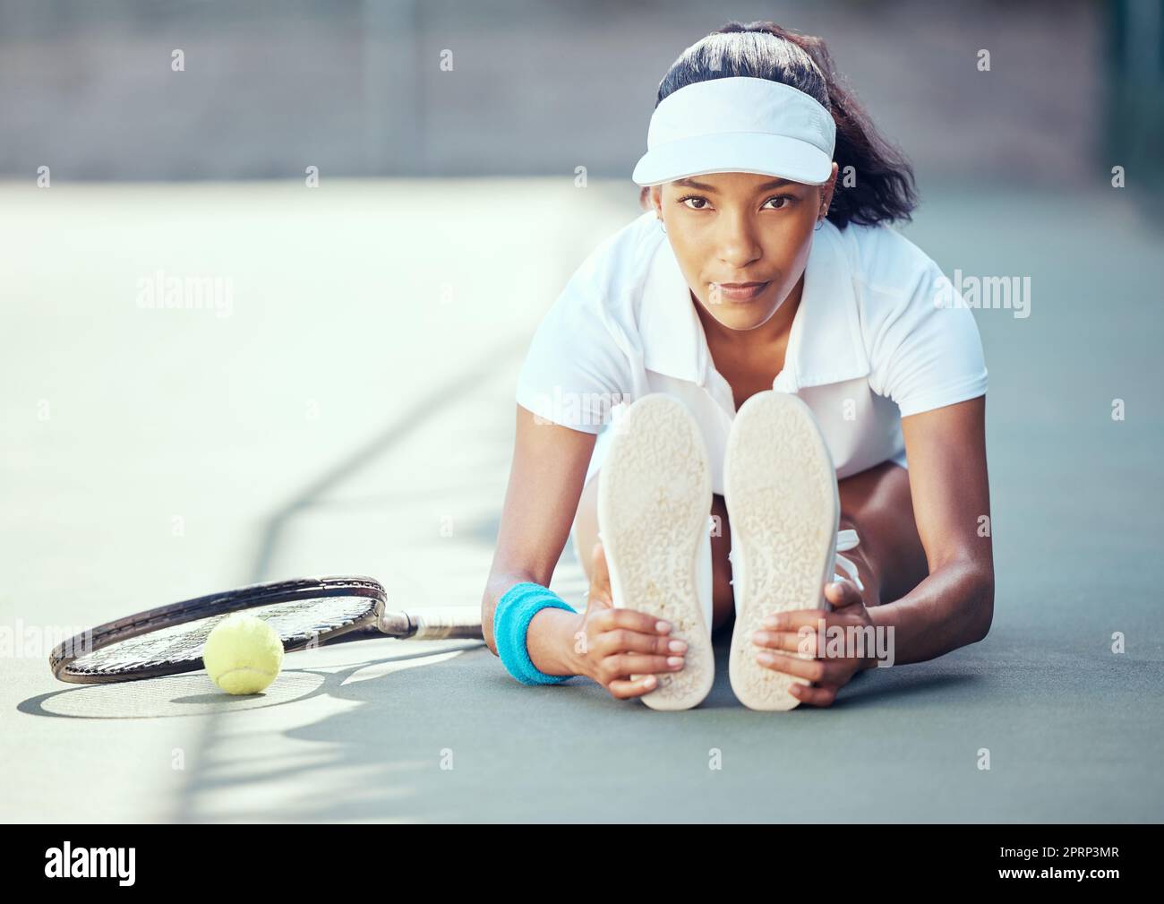Tennis, sport and exercise with a woman stretching to warmup before a game or match on an outdoor court. Health fitness and sports with a female player getting ready for a workout and practice Stock Photo