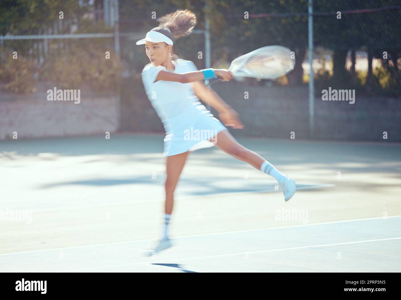 Tennis, action and active woman athlete playing sports, fitness and workout on game court. Training, motion and professional tennis player using racket to hit ball in competition match Stock Photo
