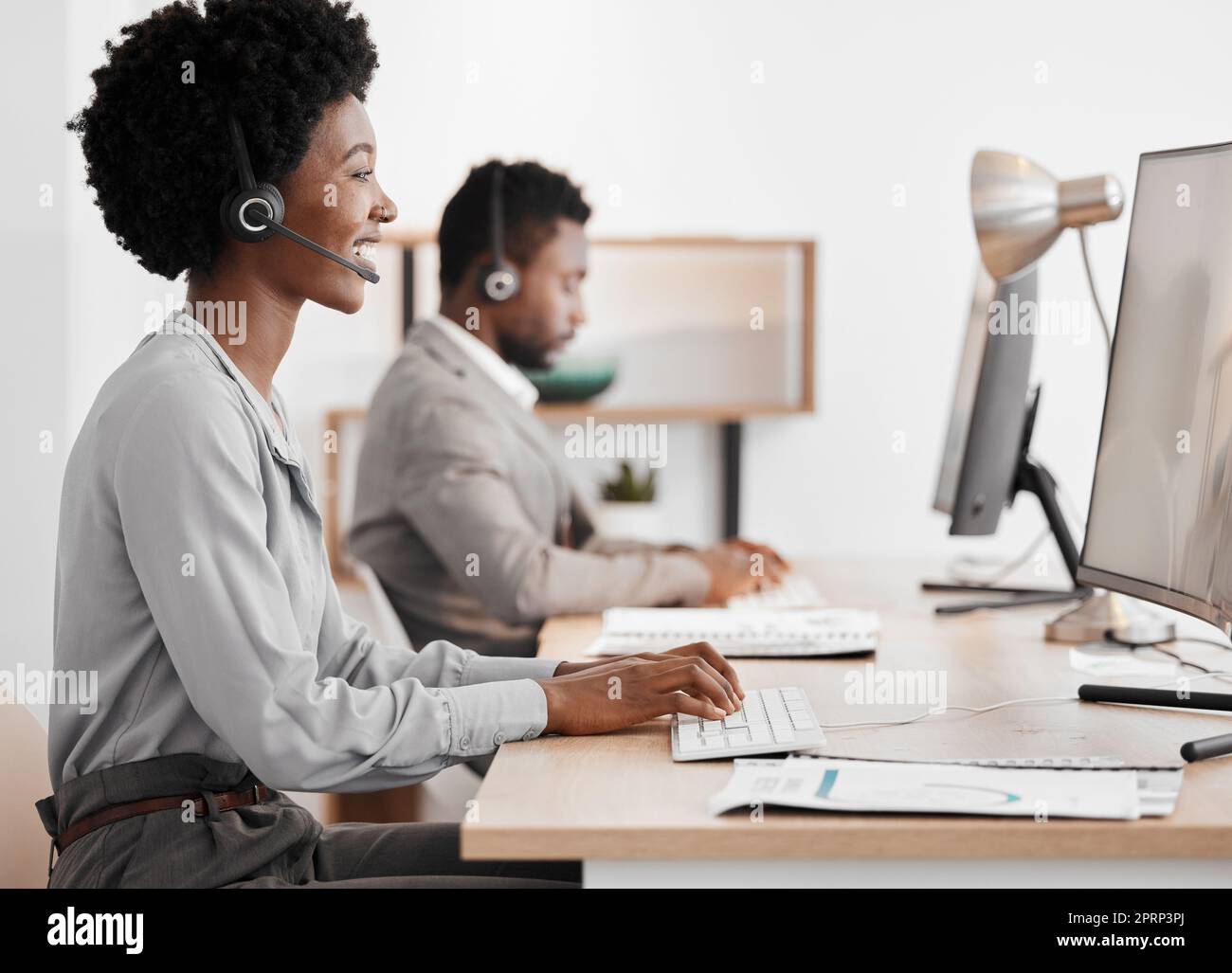 Sales woman, call center agent and customer service support employee for advice, help and expert communication working on office computer. Young internet consultant, crm telemarketing and contact us Stock Photo