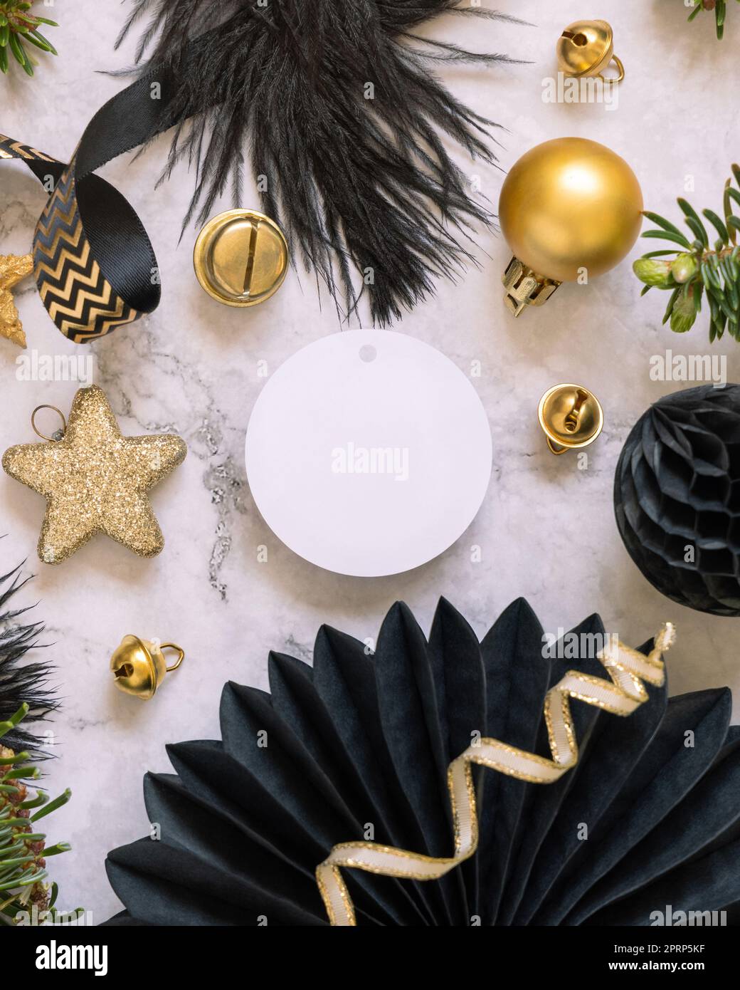 Blank round gift tag between black and golden Christmas decorations ...