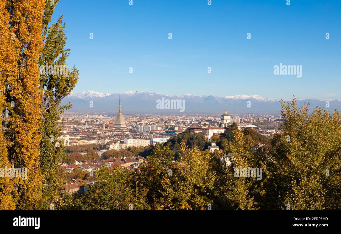 Turin panorama with Alps and Mole Antonelliana, Italy. Skyline of the symbol of Piedmont Region with Monte dei Cappuccini - Cappuccini's Hill. Sunrise light, Autumn Stock Photo