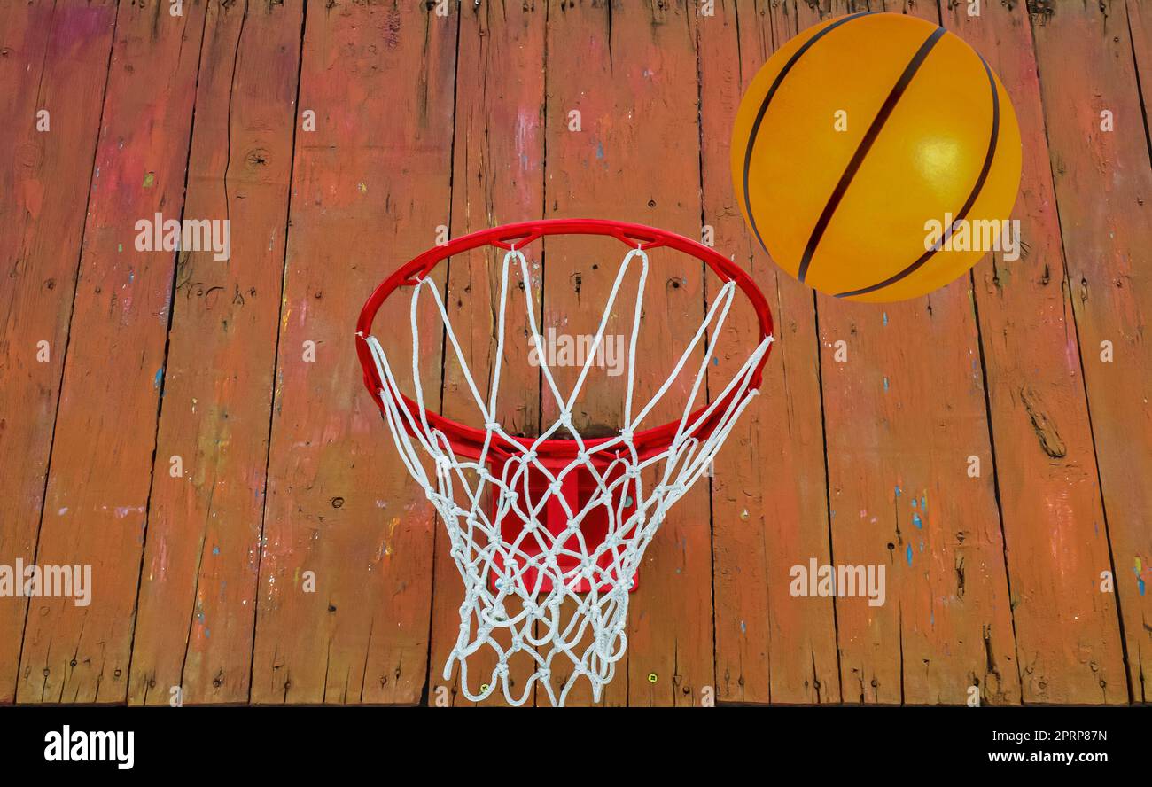 The basketball ball flies into the ring. Basketball backboard with