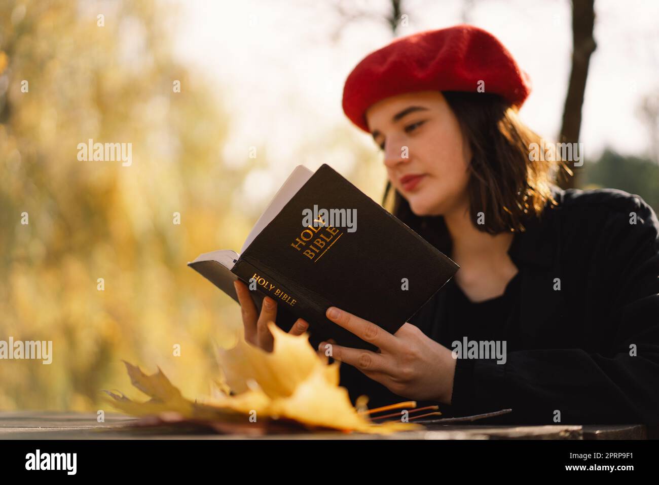Christian teen girl holds bible in her hands. Reading the Holy Bible