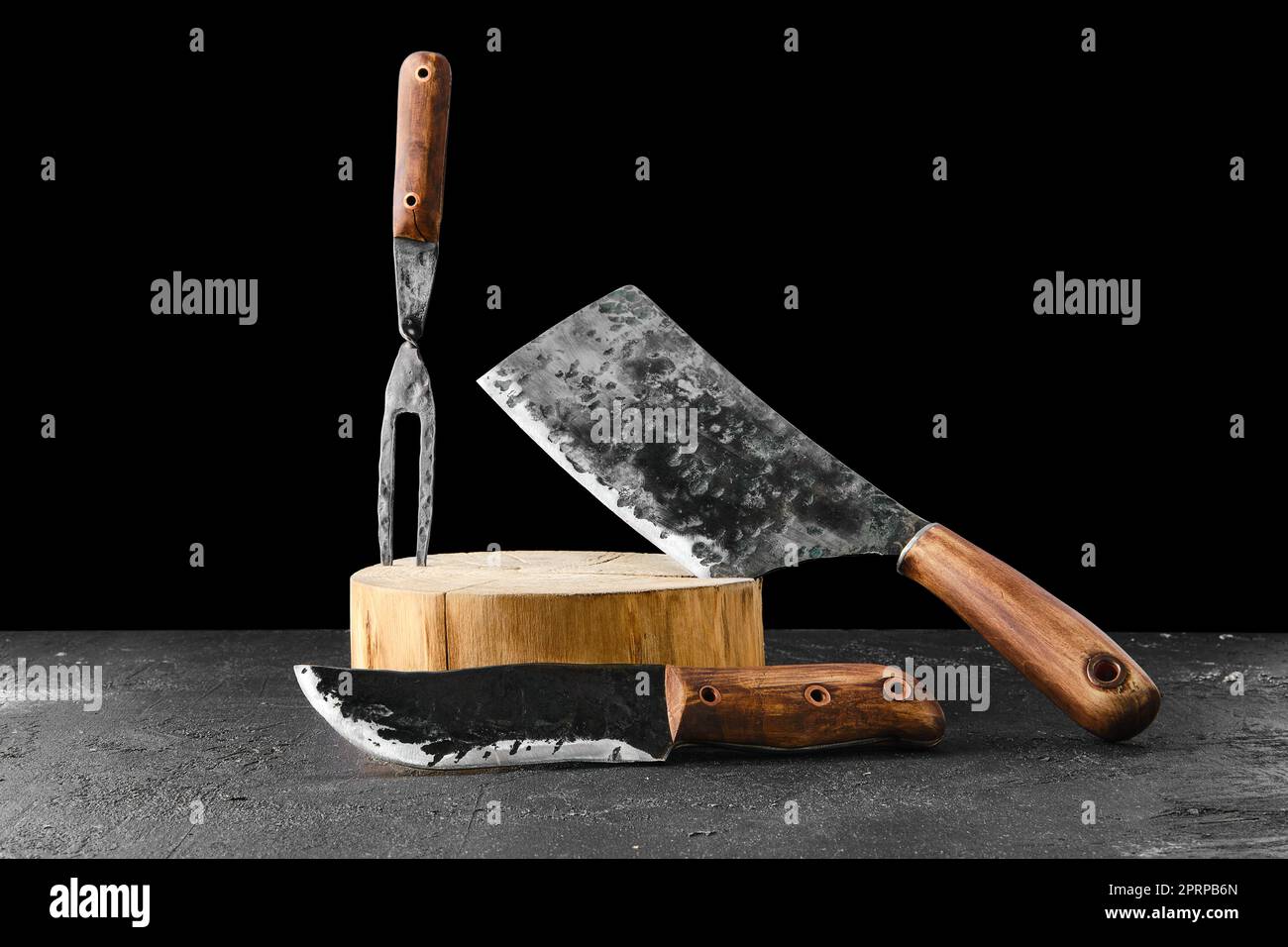 Forged butcher set on black background Stock Photo