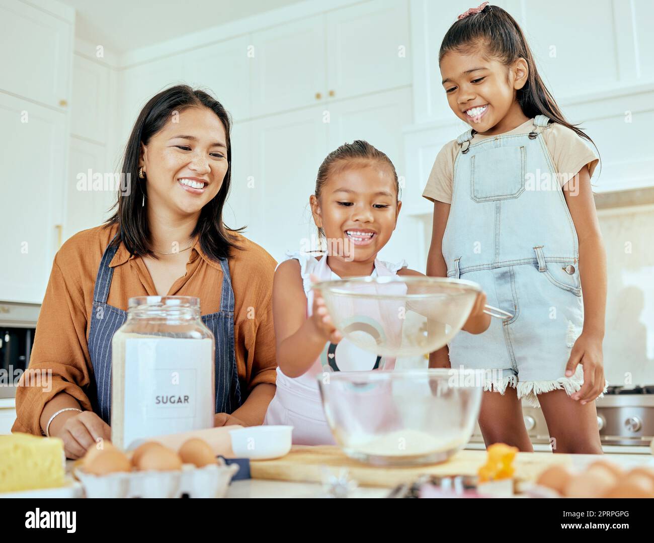 Happy little girl help mom cooking in kitchen Stock Photo - Alamy