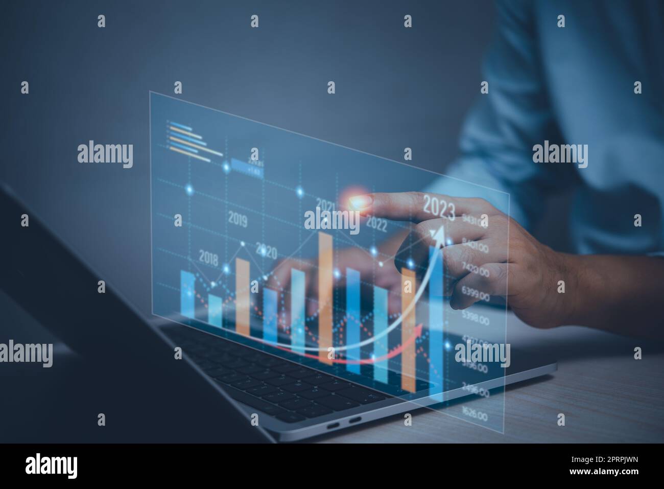 business finance technology and investment concept.Businessman increase arrow graph future growth year 2023 concept. Stock Photo