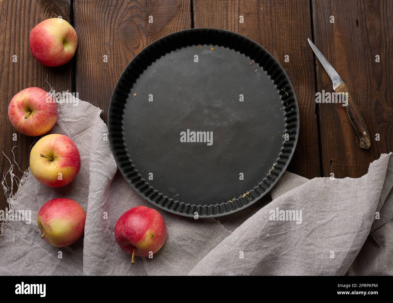 Empty black round non-stick cake pan on a brown wooden table Stock Photo