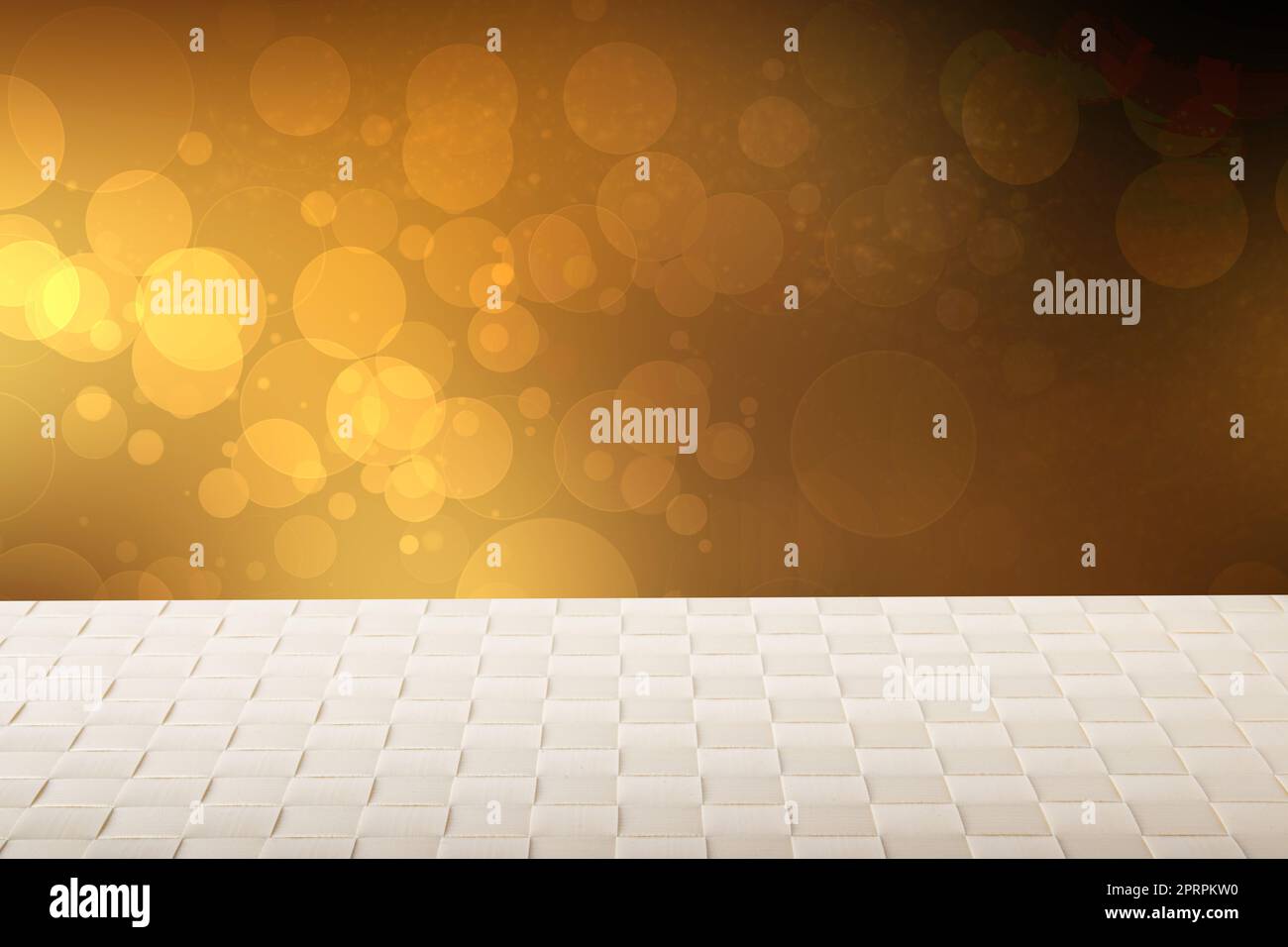 Empty table background. Empty wooden table covered with a bright tablecloth over abstract festive gold yellow background. Space for your food and product display montage. Stock Photo