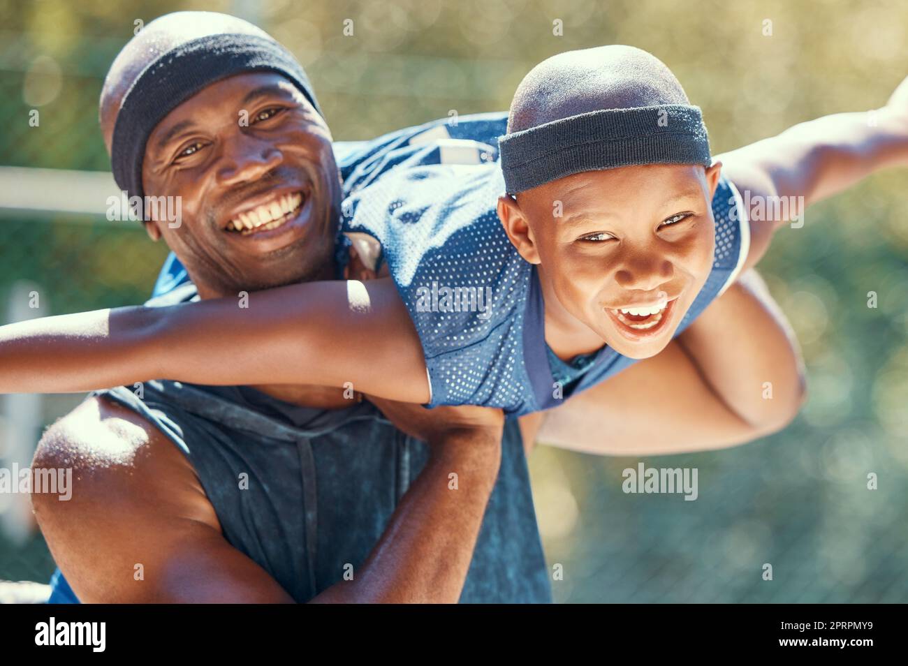 Black family, child or father on a basketball court while having fun and playing plane on a sunny day. Smile portrait of happy and excited kid with man sharing a special bond and close relationship Stock Photo
