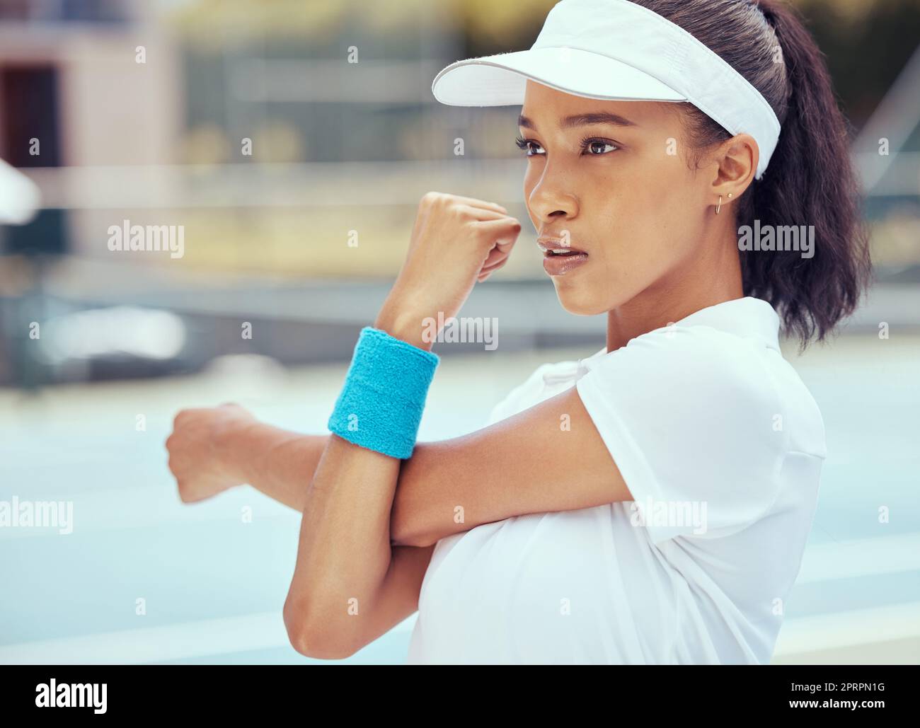 Tennis woman, competitive sport and warmup exercise with a player stretching to prepare for a game or match at an outdoor court. Fitness, competition and workout with a serious female ready to play Stock Photo
