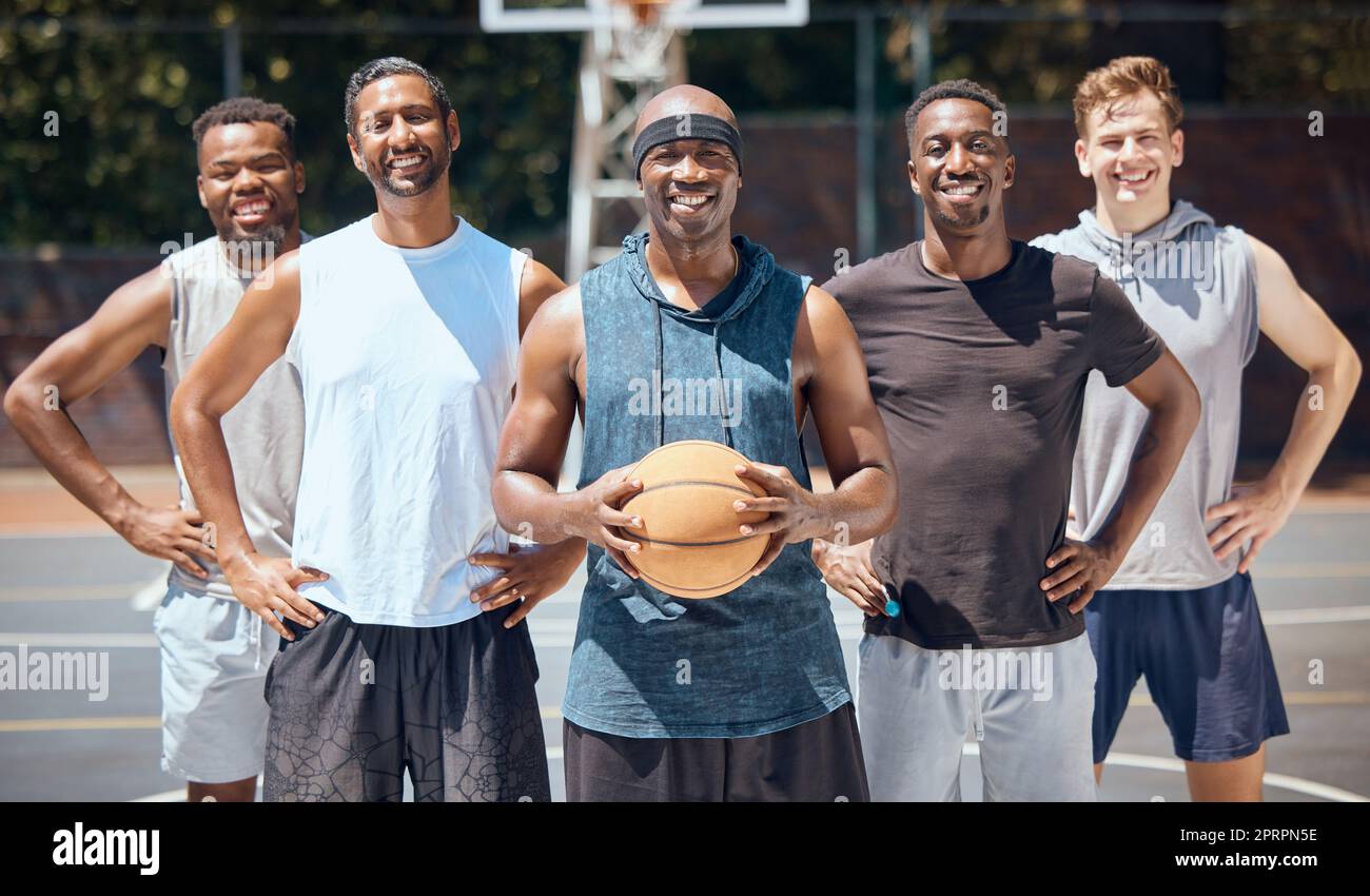 Portrait, basketball and team on sports court training for a competition, game or match with a smile. Workout, athletes and diverse picture of group playing sport for health, fitness and wellness. Stock Photo