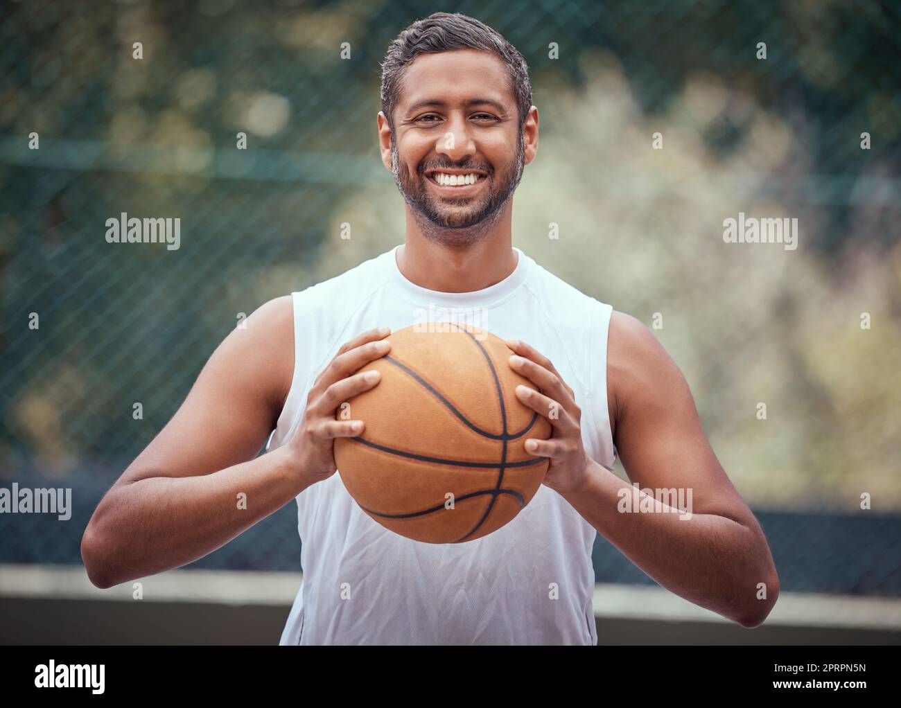 Basketball player, athlete and sports man with ball, skill and hobby for  playing game, fun match or competition outdoors. Portrait of happy, fitness  and indian man, goal motivation and ready to win