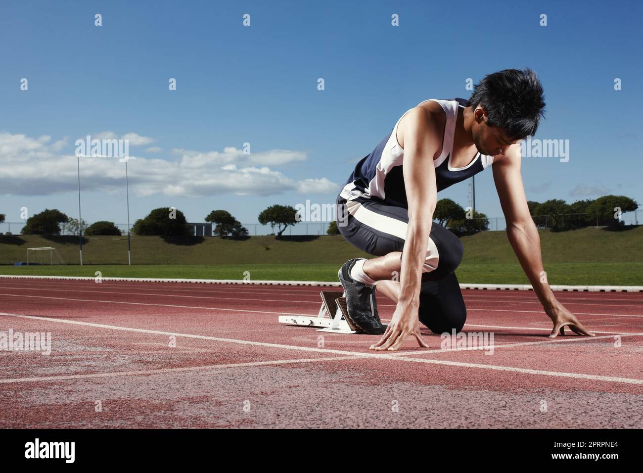 My only competition is myself. A young athlete on a starting block,. Stock Photo